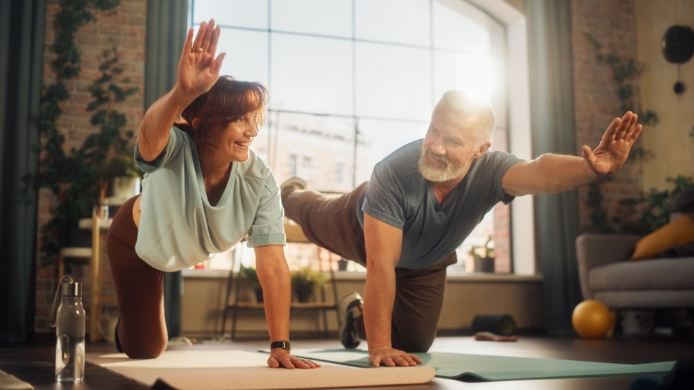 Happy,Smiling,Senior,Couple,Doing,Gymnastics,And,Yoga,Stretching,Exercises